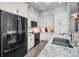Contemporary kitchen with stainless steel appliances, sleek white cabinetry, and granite countertops at 538 Walden Ct, Dunedin, FL 34698