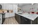 Open kitchen with island, stainless appliances and granite countertops with easy access to living area at 538 Walden Ct, Dunedin, FL 34698
