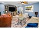 Bright living room with TV, comfortable seating, stylish rug, and colorful artwork at 538 Walden Ct, Dunedin, FL 34698
