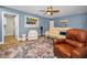 Spacious living room with comfortable seating and access to a nearby bathroom at 538 Walden Ct, Dunedin, FL 34698