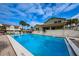 Community pool is the focus of this shot showing a large rectangular pool with lounge seating at 538 Walden Ct, Dunedin, FL 34698