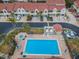 Aerial view of a community pool and spa surrounded by lounge chairs and lush landscaping at 538 Walden Ct, Dunedin, FL 34698