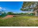 Well-maintained outdoor tennis court and green space offer recreational opportunities within the community at 538 Walden Ct, Dunedin, FL 34698