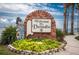 Charming 'Welcome to Dunedin' sign with brickwork and lush landscaping at 538 Walden Ct, Dunedin, FL 34698
