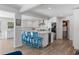 Well-lit kitchen featuring white cabinets, stainless steel appliances, and a large island with seating at 5973 Leeland S St, St Petersburg, FL 33715