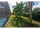 The backyard offers lush landscaping and a screened pool for added privacy and enjoyment at 6915 Sea Stone Ct, Apollo Beach, FL 33572