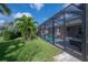 A fully screened pool with lush landscaping and a backyard area, creating a private oasis at 6915 Sea Stone Ct, Apollo Beach, FL 33572
