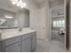 Bathroom with double sinks, white counter tops and view to bedroom at 6915 Sea Stone Ct, Apollo Beach, FL 33572