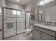 Bathroom featuring a glass-enclosed shower, granite countertop, and white tiled walls at 6915 Sea Stone Ct, Apollo Beach, FL 33572