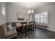 Dining area with a modern chandelier and window shutters for ambient lighting control at 6915 Sea Stone Ct, Apollo Beach, FL 33572