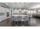 Bright kitchen featuring a large island, pendant lighting, stainless steel appliances, and hardwood floors at 6915 Sea Stone Ct, Apollo Beach, FL 33572