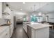 Spacious kitchen with a large center island, wood floors, stainless steel appliances and outdoor view at 6915 Sea Stone Ct, Apollo Beach, FL 33572