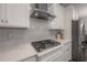 Modern kitchen featuring white cabinets, subway tile backsplash, and stainless steel appliances at 6915 Sea Stone Ct, Apollo Beach, FL 33572