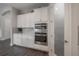 Bright kitchen boasts stainless steel appliances, white cabinetry, and wood-look floors at 6915 Sea Stone Ct, Apollo Beach, FL 33572