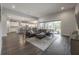 Spacious living room with a large sectional sofa, hardwood floors, and an open view of the kitchen at 6915 Sea Stone Ct, Apollo Beach, FL 33572