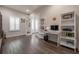 Bright office features wood floors, white shelving, and an abundance of natural light at 6915 Sea Stone Ct, Apollo Beach, FL 33572