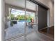 Covered patio area with view of the screened-in pool and tropical landscaping at 6915 Sea Stone Ct, Apollo Beach, FL 33572