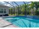 Beautiful screened pool featuring a waterfall feature and steps for easy access at 6915 Sea Stone Ct, Apollo Beach, FL 33572