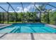 Close-up of a waterfall feature in a screened pool at 6915 Sea Stone Ct, Apollo Beach, FL 33572