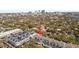 Overhead view highlighting the property among lush trees and city views in the distance at 711 S Oregon Ave, Tampa, FL 33606