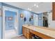 Bright blue bathroom with a large mirror, vanity, and a separate shower and toilet area at 711 S Oregon Ave, Tampa, FL 33606