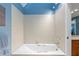 Bright bathroom features a large tiled tub under a skylight providing natural light at 711 S Oregon Ave, Tampa, FL 33606