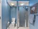 Cozy bathroom features a glass door shower and toilet in a vibrant blue setting at 711 S Oregon Ave, Tampa, FL 33606