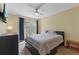 Cozy bedroom with a large window, ceiling fan, and a comfortable queen bed at 711 S Oregon Ave, Tampa, FL 33606