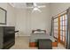 Bedroom features a bed, closet, desk, fan and doors to a balcony providing natural light at 711 S Oregon Ave, Tampa, FL 33606