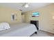 Bedroom with ceiling fan, TV, queen-sized bed, and a window letting in natural light at 711 S Oregon Ave, Tampa, FL 33606