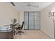 Bedroom featuring a desk, closet with frosted glass doors, and a ceiling fan at 711 S Oregon Ave, Tampa, FL 33606