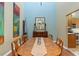 Elegant dining room featuring a large wooden table, high ceilings, and colorful artwork at 711 S Oregon Ave, Tampa, FL 33606