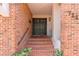 Charming brick entrance with double doors, stairs, and decorative address numbers at 711 S Oregon Ave, Tampa, FL 33606