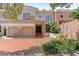 Inviting townhome with brick accents, a two-car garage, and lush landscaping at 711 S Oregon Ave, Tampa, FL 33606