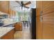 Well-lit kitchen features stainless steel appliances, granite countertops, and wooden cabinets at 711 S Oregon Ave, Tampa, FL 33606