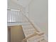 Bright stairway with white railings and light wood steps leads to a landing with a door at 711 S Oregon Ave, Tampa, FL 33606