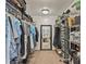 Spacious walk-in closet with ample storage, shelving, and a clear view into the bathroom at 711 S Oregon Ave, Tampa, FL 33606