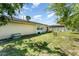 This backyard features a grassy lawn, a shed, patio seating, and mature trees at 712 Hazy Meadow Ct, Brandon, FL 33510