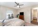 Bedroom features a ceiling fan, dresser, and ensuite bathroom at 712 Hazy Meadow Ct, Brandon, FL 33510