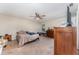 Spacious bedroom with ceiling fan, dresser, and carpeted floors at 712 Hazy Meadow Ct, Brandon, FL 33510