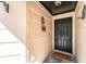 Covered front porch with welcome sign and dark front door with hardware at 712 Hazy Meadow Ct, Brandon, FL 33510