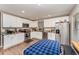 Bright kitchen with white cabinets, stainless steel appliances, and granite countertops at 712 Hazy Meadow Ct, Brandon, FL 33510