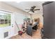 Room with ceiling fan, wood floors, shelves, and a side door to the outdoors at 712 Hazy Meadow Ct, Brandon, FL 33510