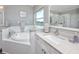 Bright bathroom featuring double sinks, soaking tub, and bright countertops at 7164 Conch Blvd, Seminole, FL 33777