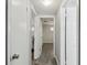 Hallway with multiple rooms and closets with a continuation of the stylish wood-look tile flooring at 7724 Dale Dr, Port Richey, FL 34668