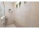 Spacious walk-in shower with stone tile and a rainfall shower head at 7836 Yale Harbor Dr, Wesley Chapel, FL 33545