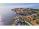 Aerial view of waterfront property with lush trees and foliage along the coastline and neighborhood at 100 Driftwood W Dr, Palm Harbor, FL 34683