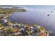 Wide aerial view of waterfront property with surrounding homes, docks, and waterway at 100 Driftwood W Dr, Palm Harbor, FL 34683