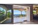 A view from the tiled, covered balcony showcasing picturesque ocean views at 100 Driftwood W Dr, Palm Harbor, FL 34683