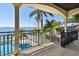 Balcony view of the swimming pool, backyard, and waterfront at 100 Driftwood W Dr, Palm Harbor, FL 34683